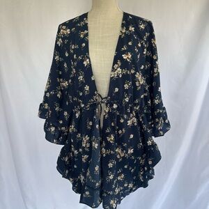 Tru navy blue floral print kimono wrap featuring a tie front and ruffled edges.